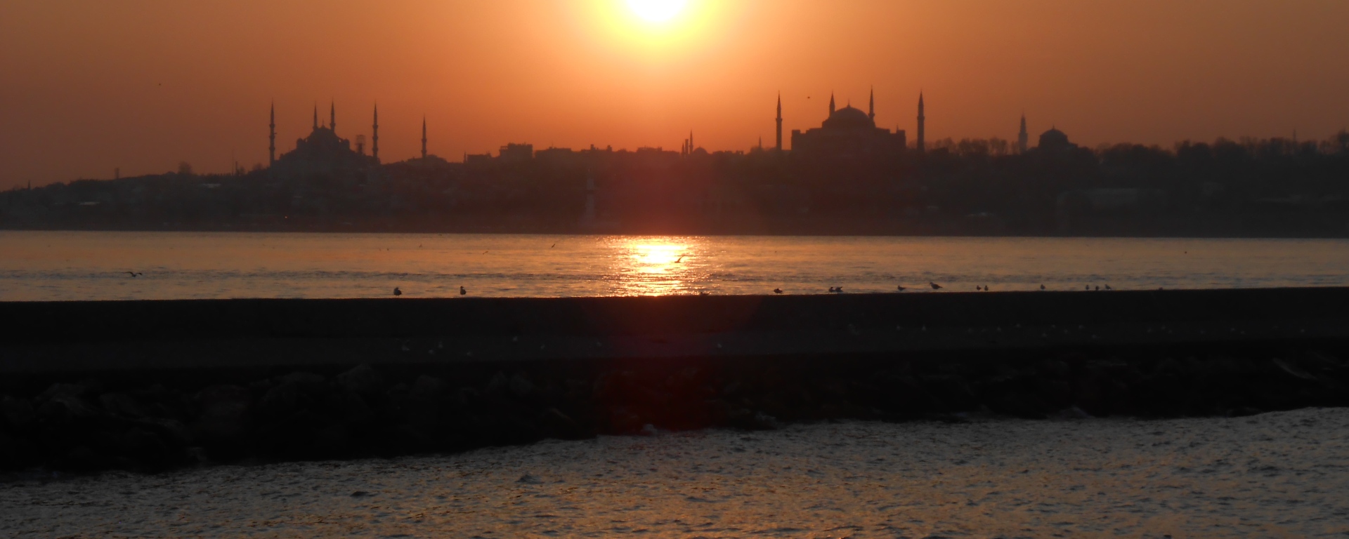 Mosques and minarets silhouetted by Istanbul sunset