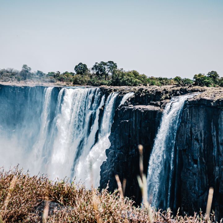 the Zambezi River's mighty Victoria Falls thunder along the Zimbabwe-Zambia border